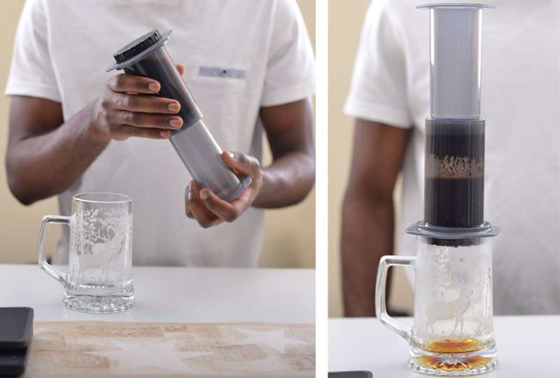 Dynamic image capturing the careful flipping of the AeroPress onto a mug. The image freezes the action, emphasizing precision and control during this crucial step.